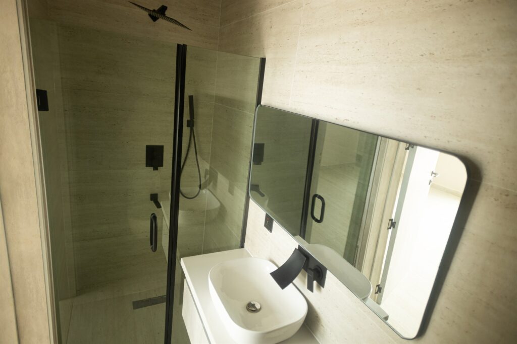 Brum Height 6: Bathroom vanity, mirror and glass shower enclosure